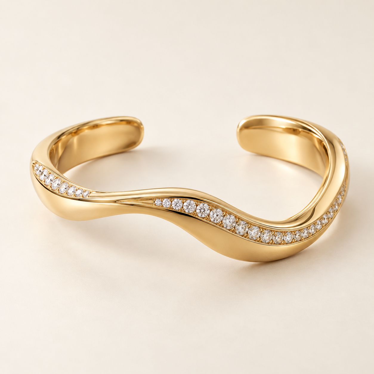 Open sculptural 18K yellow gold cuff with asymmetric diamond-set waves